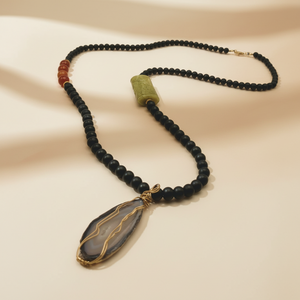 A black onyx beads necklace with dark agate pendant and gold-filled accents.