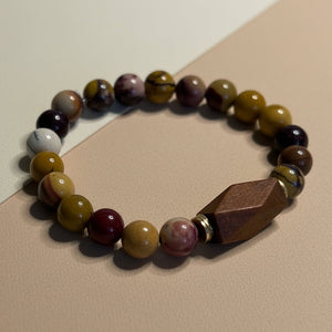 Beaded bracelet with multicolored jasper beads on a white surface